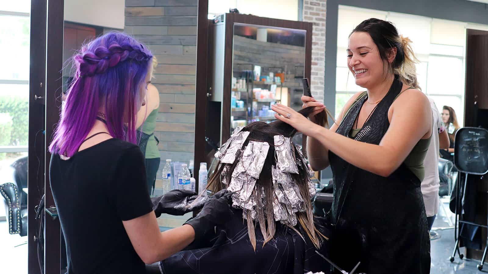 Our stylist and her assistant touching up the color on their client