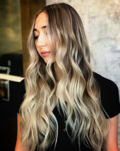Woman with long blonde dimensional balayage