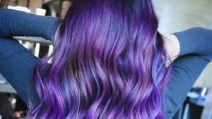 woman with vibrant purple hair with blue highlights