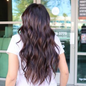 Woman with long brunette hair with a dimensional balayage