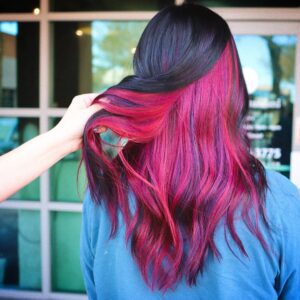 woman with a red, purple, and pink fantasy color look