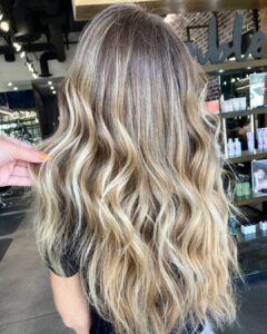 Woman with blended blonde to cover her greys