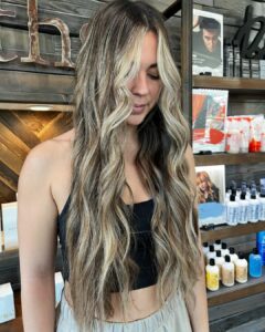 Woman with a dimensional balayage and a bold blonde money piece