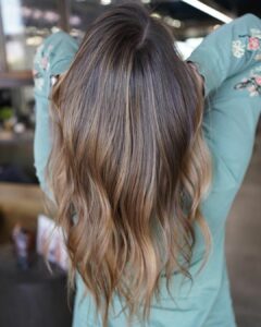 Woman with brunette hair and a caramel balayage