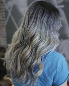 Woman with icy highlights and dark roots