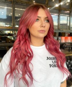 Woman with watermelon pink hair extensions