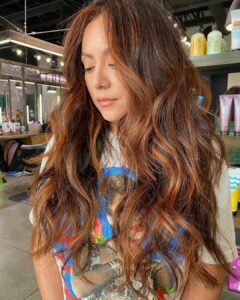 Woman with a lived-in copper balayage and bold money piece