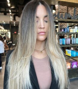 Woman with a blended balayage and bold blonde money piece