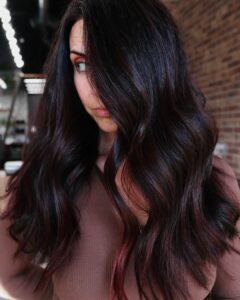 Woman with a hand painted red balayage