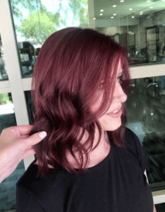 Woman with a short wine red fantasy color look