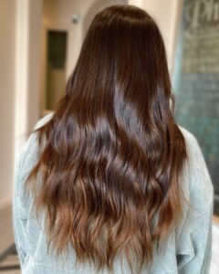 Woman with shiny brown beach waves