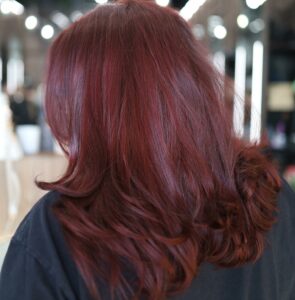 Woman with wine red colored hair