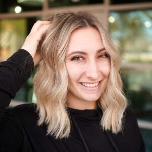 blonde woman smiling with women's haircut