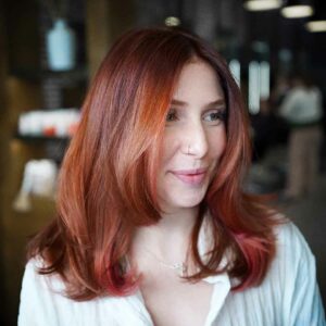 Red headed woman with a layered women's haircut