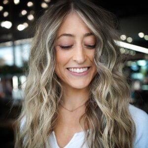 Woman smiling in Las Vegas with her dimensional balayage done at The Hair Standard
